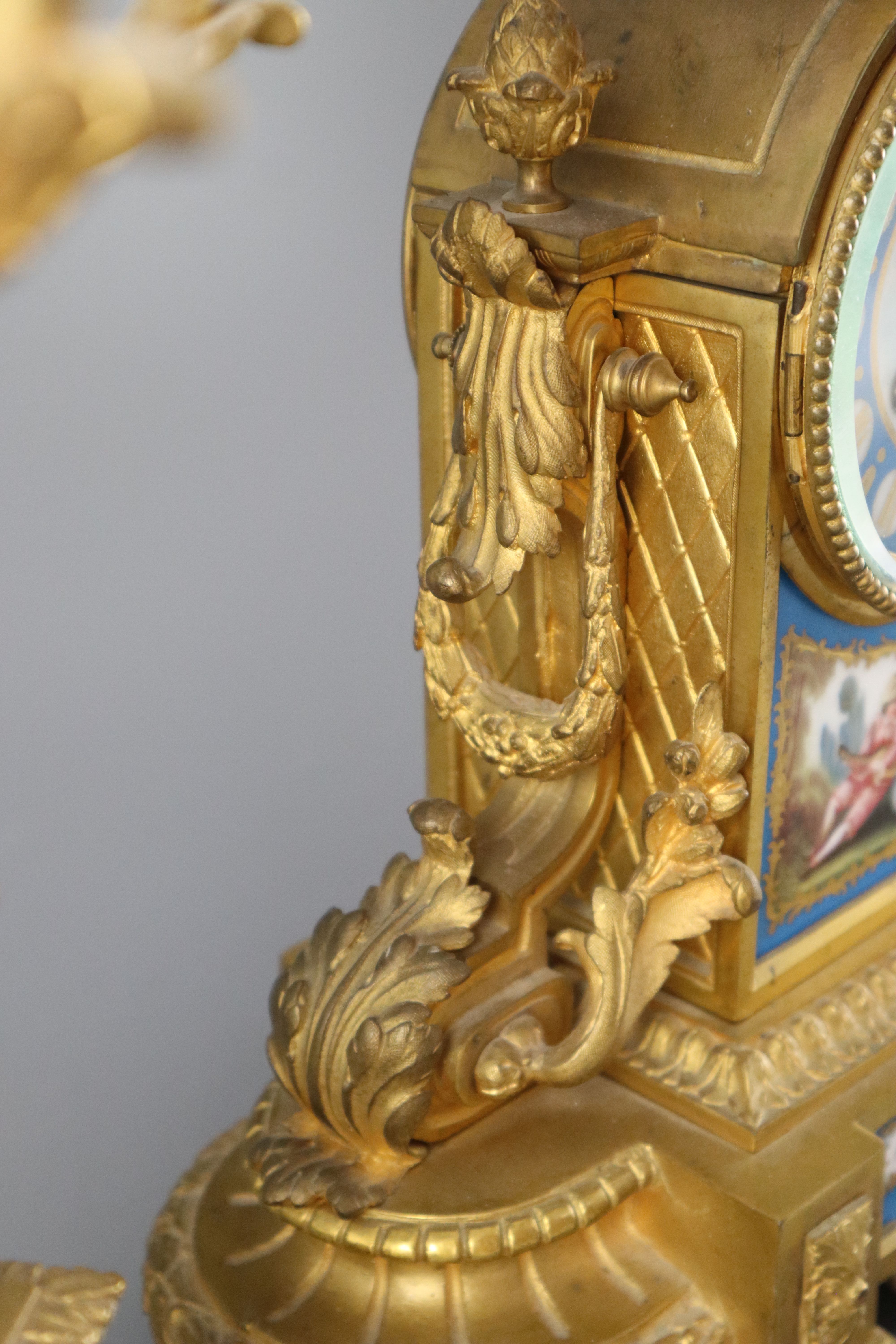 A 19th century Louis XVI style ormolu and Sevres style porcelain clock garniture, height 16.5in.